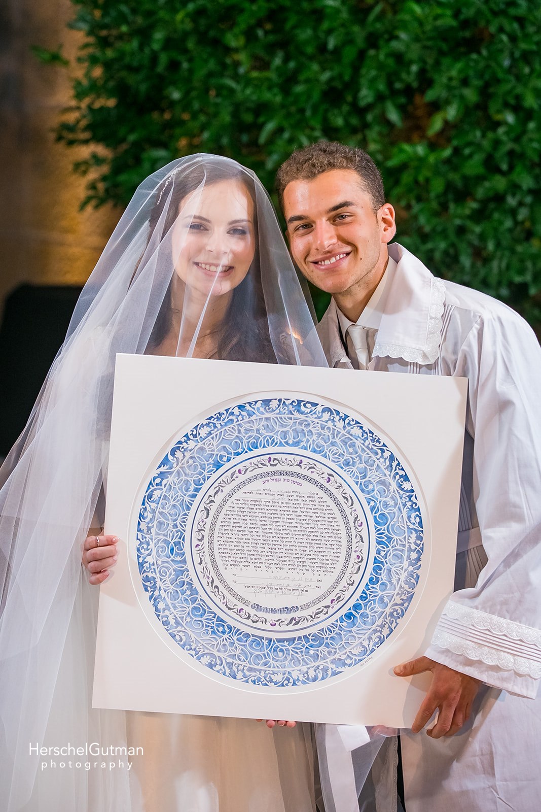 A couple admiring their beautifully displayed Ketubah